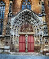 red entrance doors to an ancient church