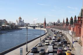Beautiful landscape of the road with cars, near the river and church