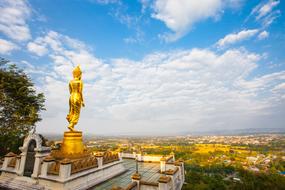 Buddhism gold statue and sky