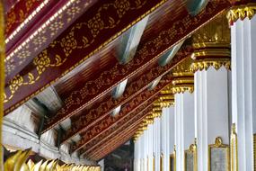 Beautiful ornamental temple with white and gold columns in Bangkok, Thailand