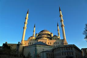 Minaret with towers against the blue sky