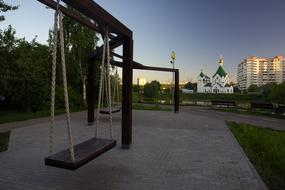 swing near the church in Novokosino at dusk