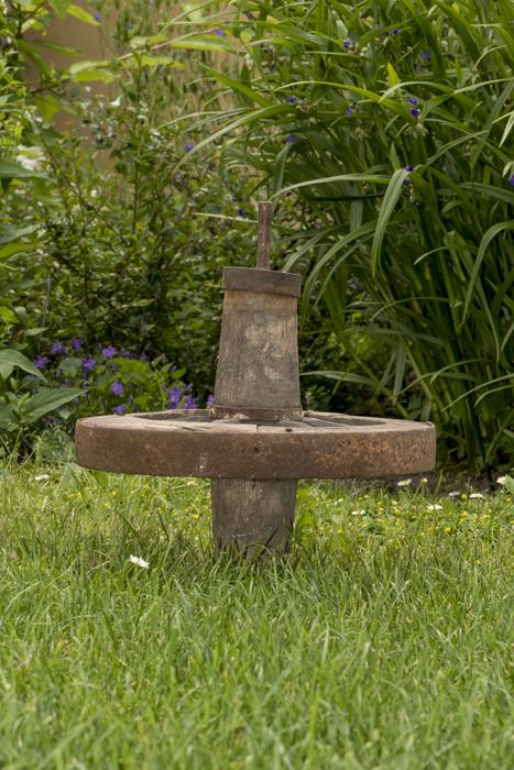 Antique cart wheel in the field