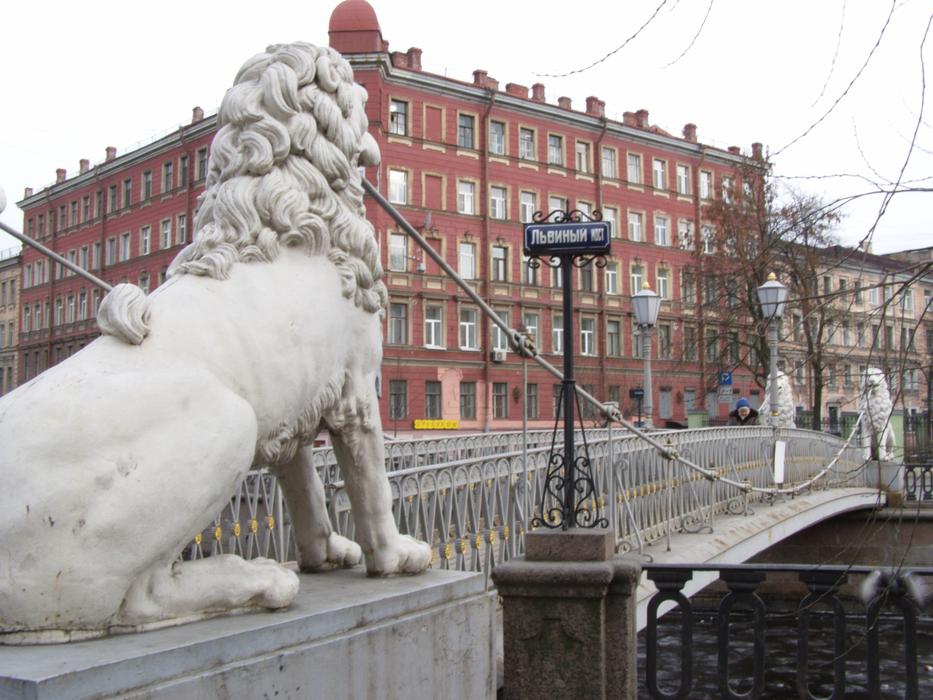 stone sculpture of a lion by the bridge