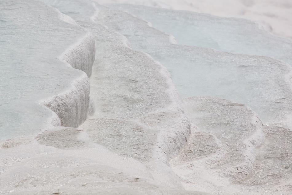 white sand on a beach by the ocean