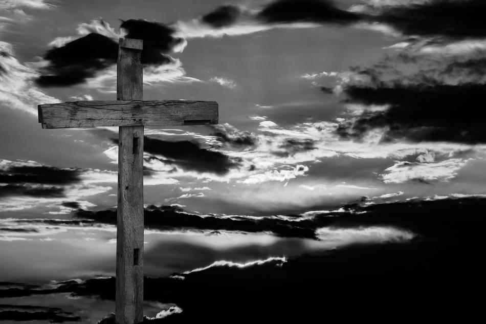 wooden cross on a background of clouds