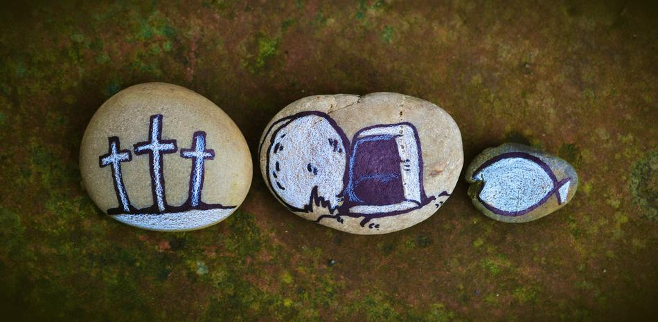 closeup picture of painted crosses and gravestones on pebbles