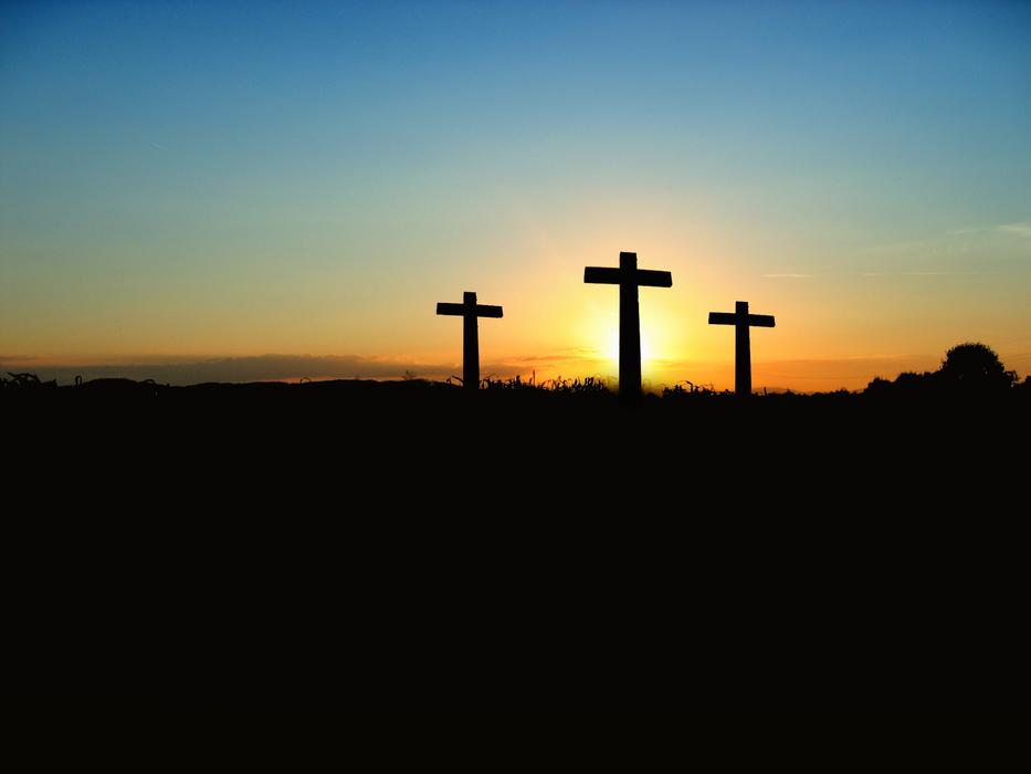 Crosses on the hill, at colorful and beautiful, gradient sunset in the sky