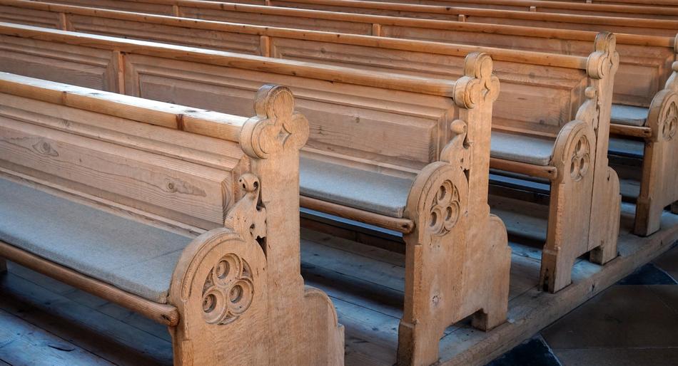 Beautiful ornamental wooden benches in the church