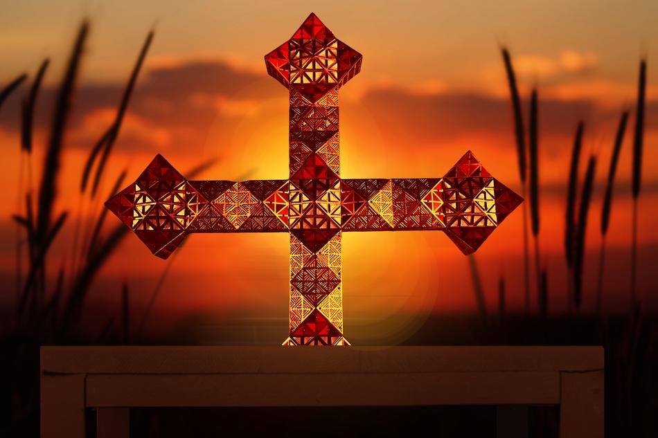 cross on sunset background with blurred background