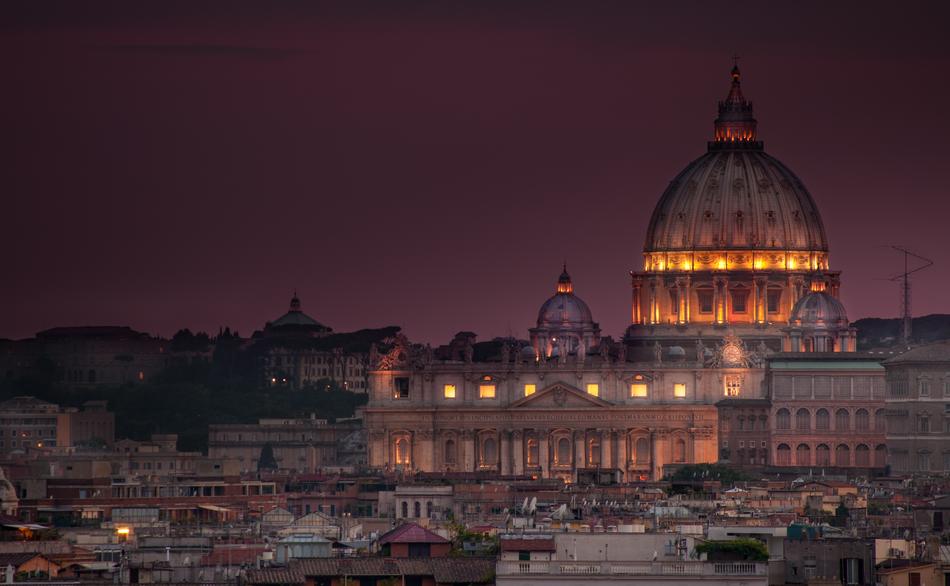 illuminated st peter’s cathedral in city at dusk, italy, rome