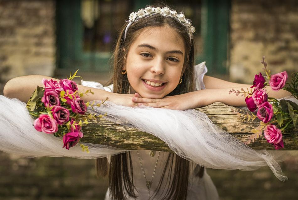 photo of a girl and flowers on the background of the church