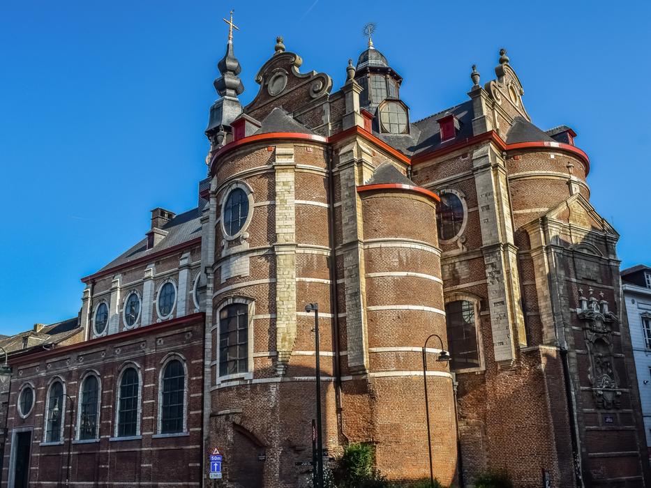 Beautiful and colorful church in Brussels, Belgium, in light and shadow, at blue sky on background