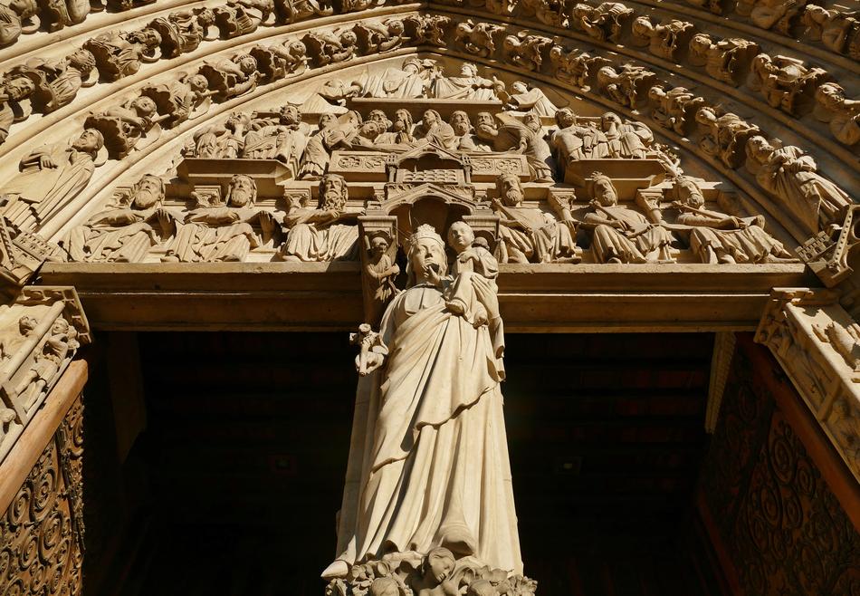 statue near the entrance to the church in paris