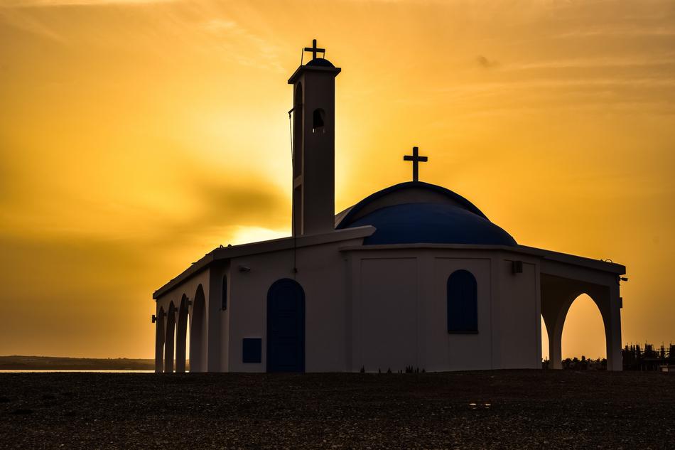 silhouette of a church in cyprus at sunset