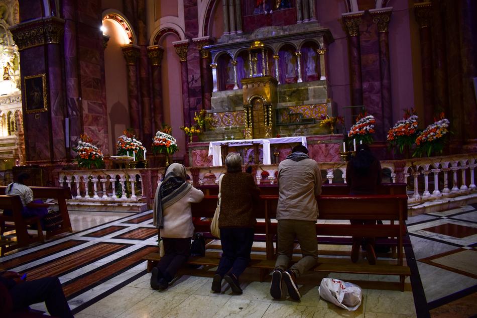 praying people by the altar
