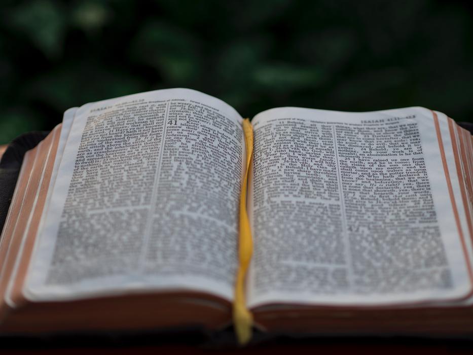 open bible in blurred background