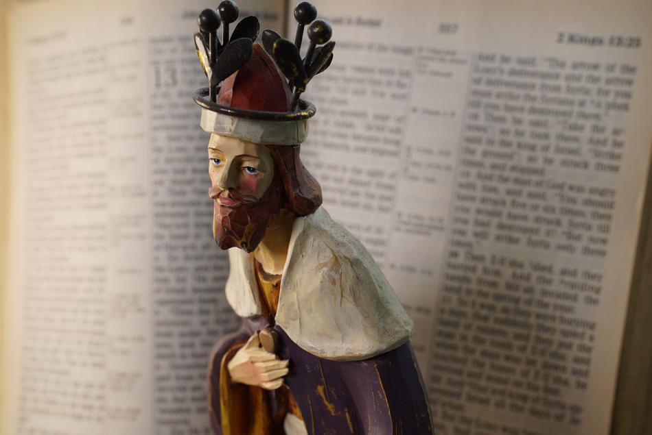 religious figure on open bible background