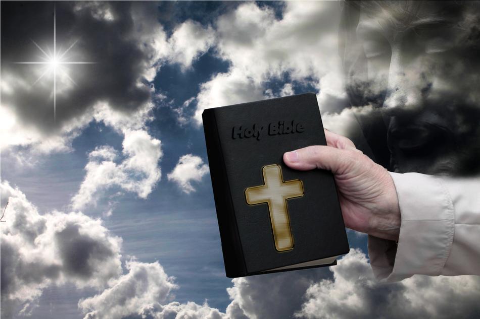 clipart of bible book in hand at background of sky
