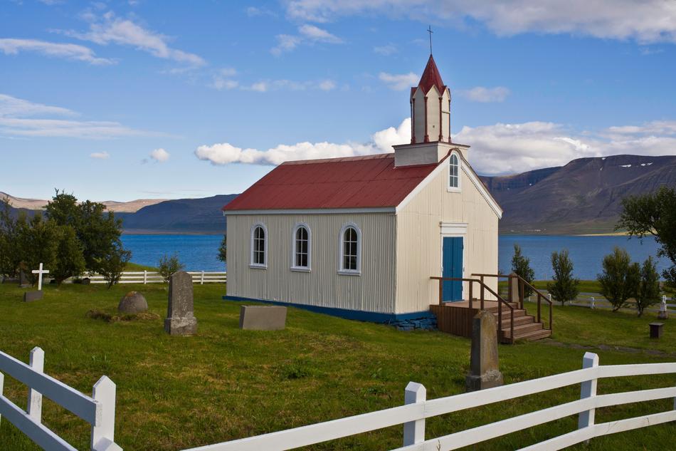 small church with a red roof among the landscapes of iceland