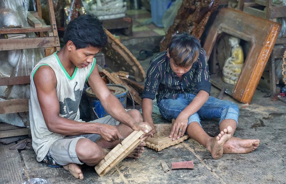 Boys, carving things from the wood, in Yangon, Myanmar
