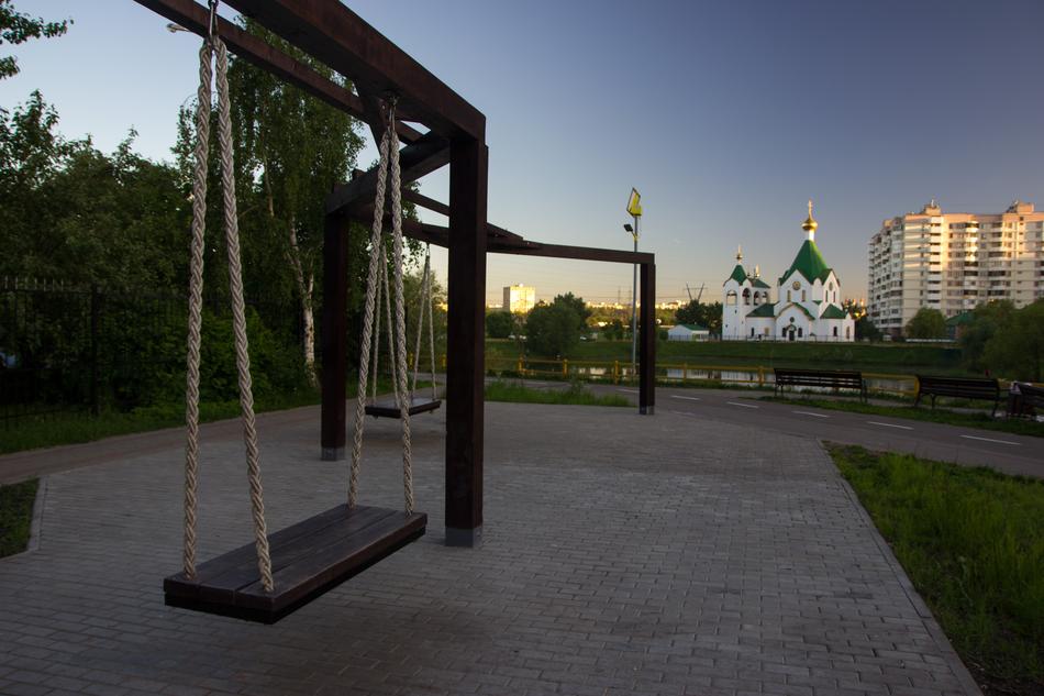 swing near the church in Novokosino at dusk