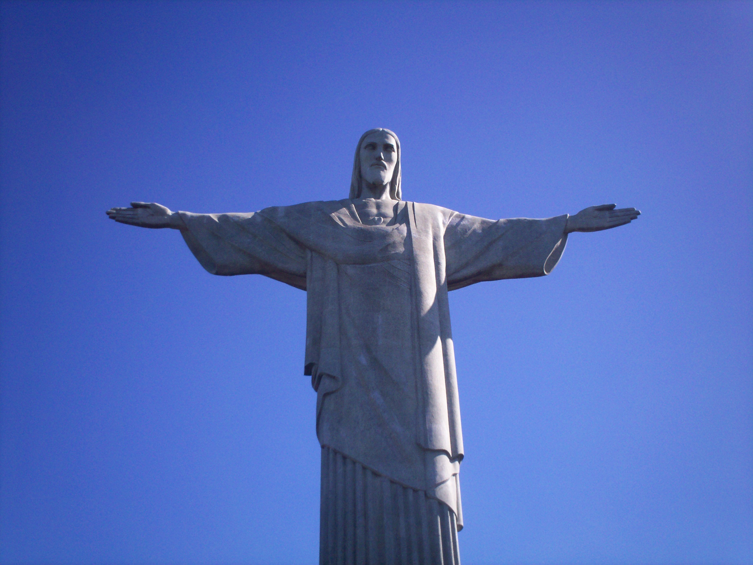Beautiful Statue Of Jesus Christ In Light And Shadow On The Mountain In Rio De Janeiro Brazil Under The Blue Sky Free Image Download