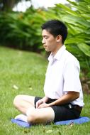 Meditation Buddhist Boy gren grass, thailand