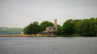 Beautiful Heilndskirche church on the coast among the plants in Potsdam, Germany