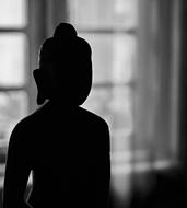 silhouette of Buddha statue