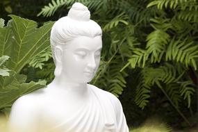 Buddha Sculpture white among the trees
