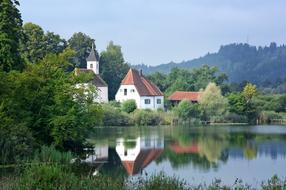 Beautiful Monastery Seeon on the coast wih colorful plants, in Chiemgau, Upper Bavaria, Germany