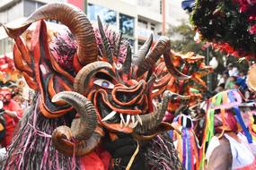 man in dragon costume at the festival in Ecuador