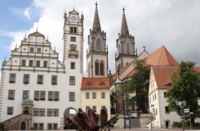 town hall building with towers in the background of clouds
