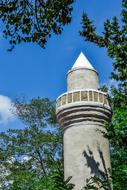 closeup view of Mosque Minaret Architecture and green tree