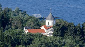 Church and green trees on Sea coast in Crimea