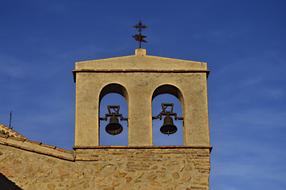 bell tower on a stone tower on a sunny day