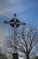 Calvary Cross Religion and trees at blue sky