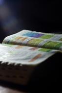 Open Bible book with colorful pages, in light