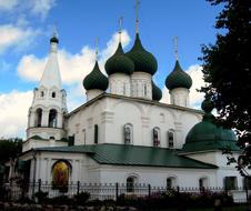 church with a white facade and green domes