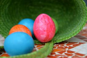 Colorful and beautiful Easter Eggs and beautiful, green wicker basket