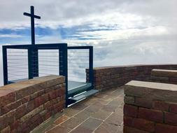 cross on a stone tower on monte tamaro
