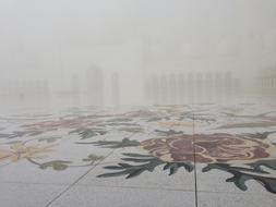 fog over flower tiles in abu dhabi