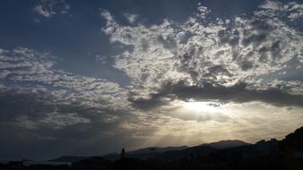 Beautiful blue sky with the white clouds with sunset, above the landscape in Liguria, Italy