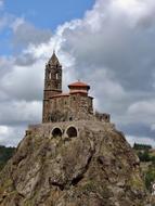 church on a rock under the clouds