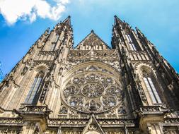 Beautiful Vitus Cathedral in Prague, Czech Republic, under the blue sky with white clouds