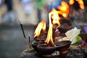burning oil lamps at a ceremony in a temple in Asia