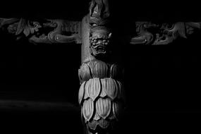Black and white photo of the beautiful sculpture with face, of the temple
