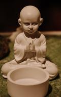 decorative buddha in meditation pose on blurred background