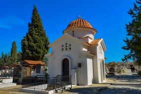 Beautiful Orthodox Church among the green trees at blue sky background in Larnaca , Cyprus, Greece